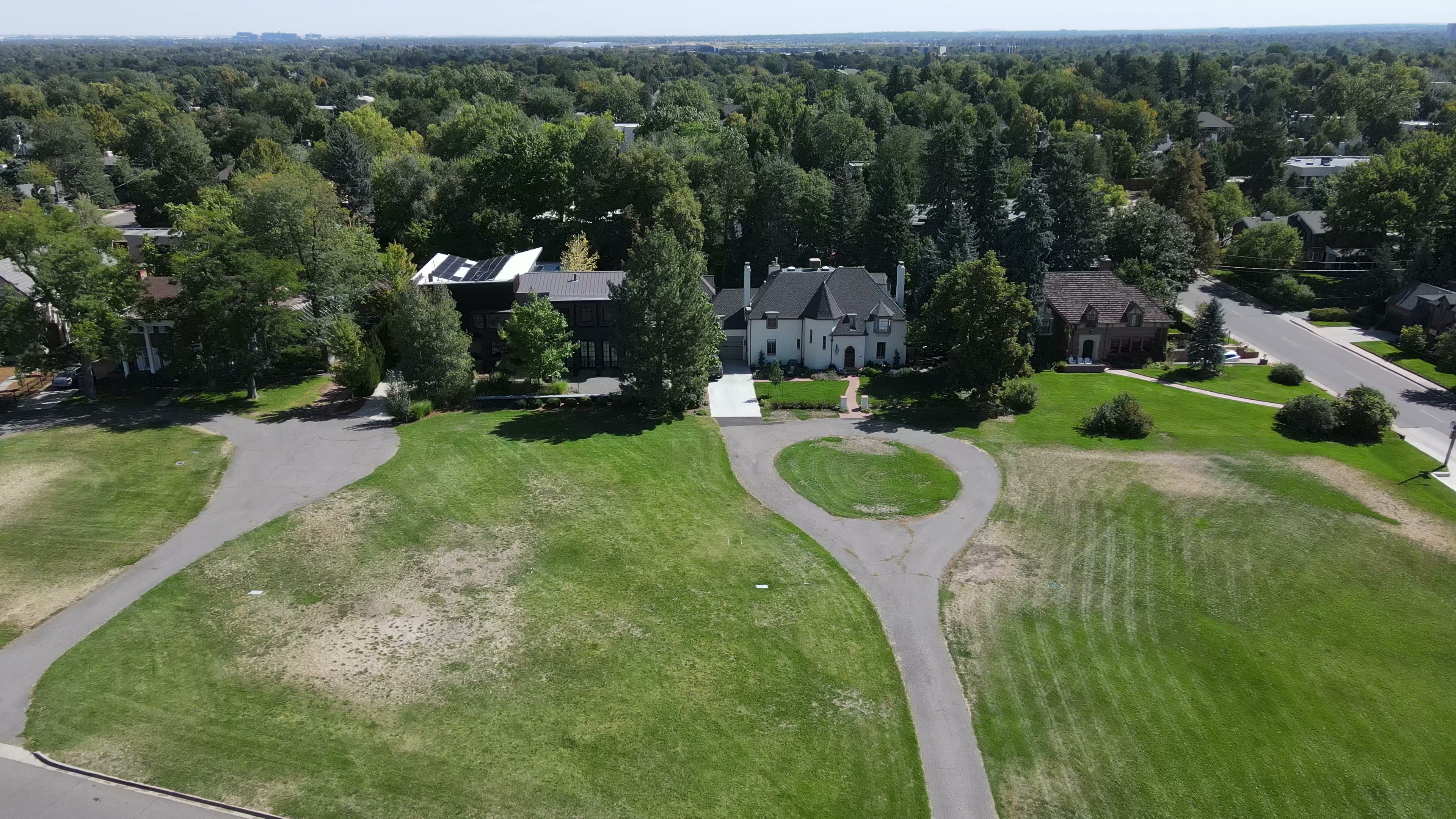 Aerial drone view of Denver Hilltop neighborhood showing luxury homes on large lots with manicured lawns and mature tree canopy
