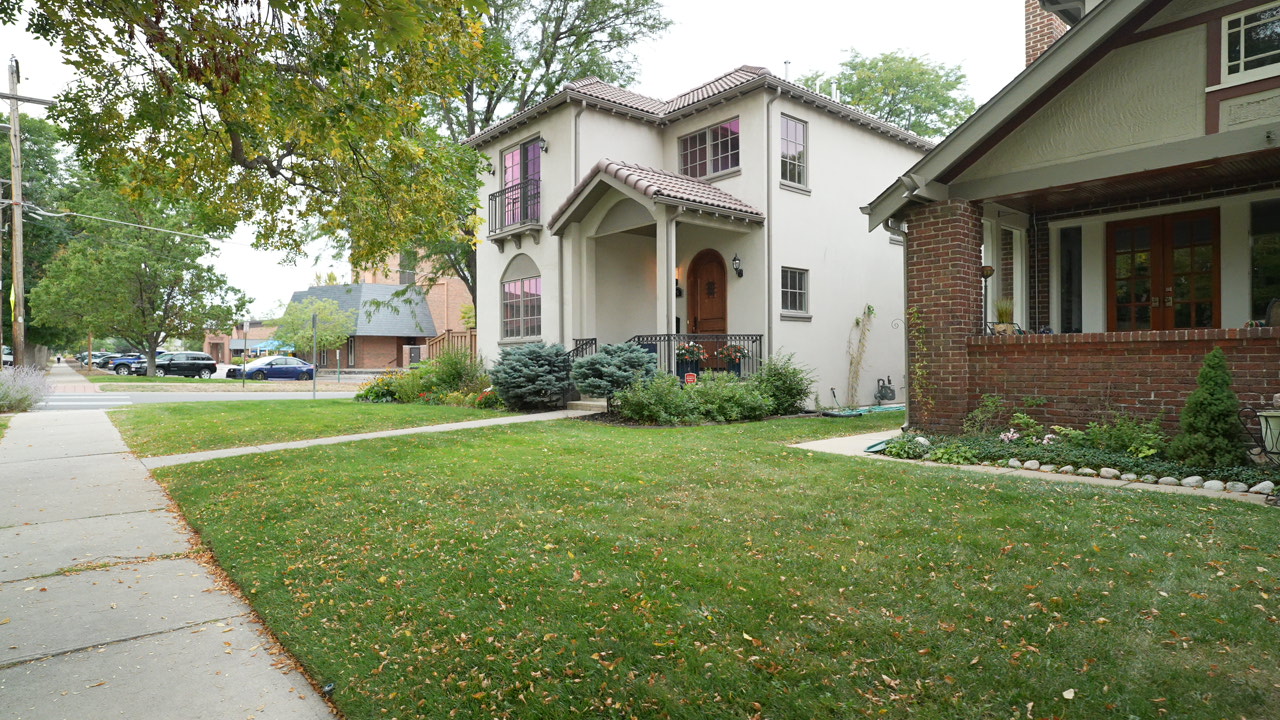 Spanish Revival stucco home with arched portico in Wash Park, Denver